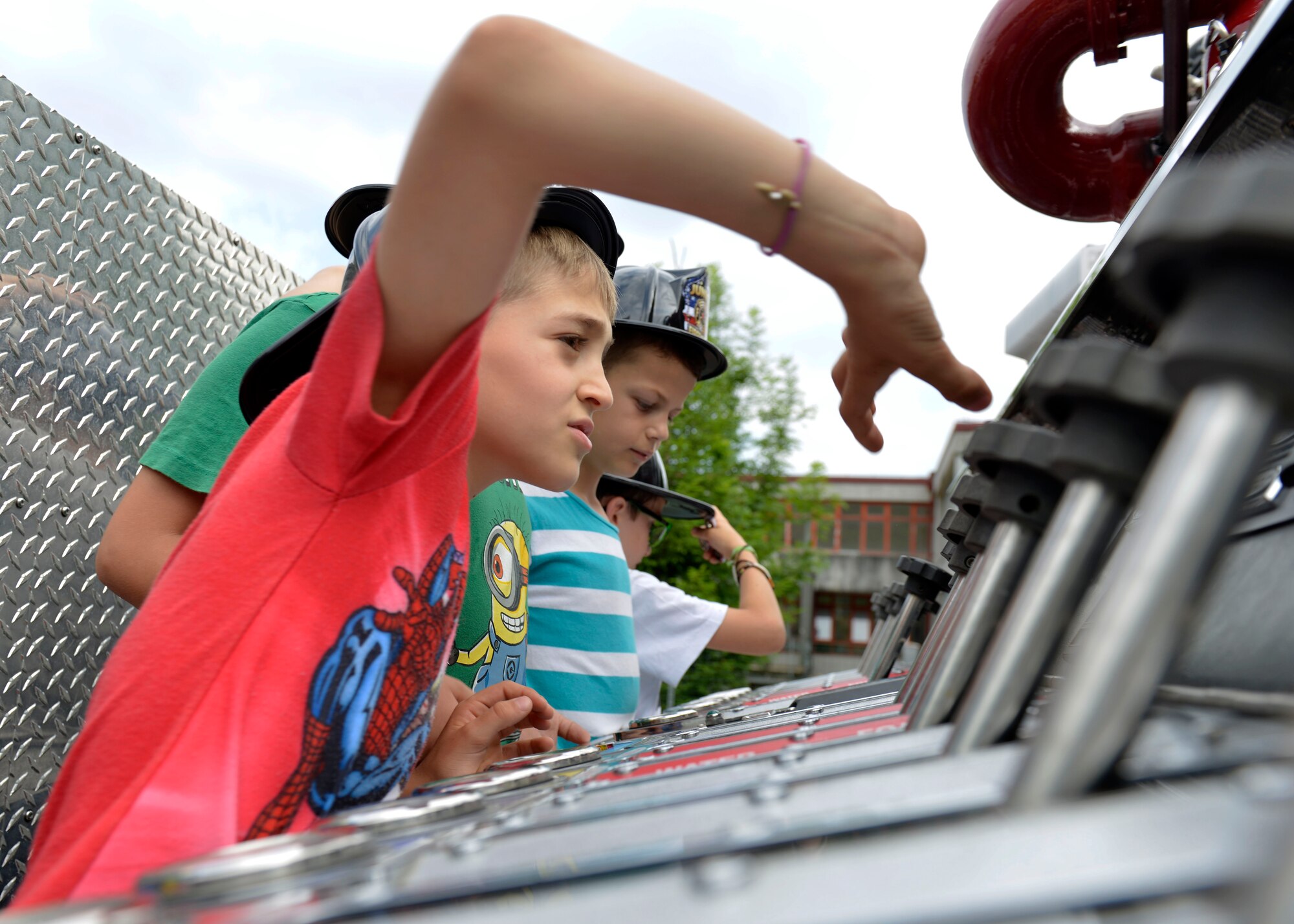 An Italian child plays with gauges on a fire truck during a visit by the 31st Civil Engineer Squadron, May 31, 2017 at Polcinego, Italy. The firefighters visited a Polcenigo elementary school to show the children firefighting equipment and to teach fire safety. (U.S. Air Force photo by Senior Airman Cary Smith)