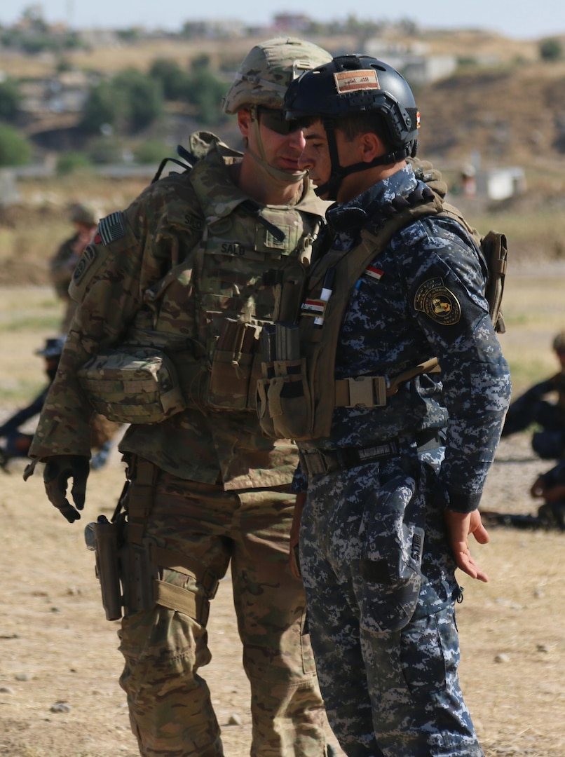 U.S. Army 1st Sgt. Erik Salo, a company first sergeant and partner force adviser assigned to 2nd BCT, 82nd Abn. Div., deployed in support of Combined Joint Task Force - Operation Inherent Resolve and assigned to the 2nd Brigade Combat Team, 82nd Airborne Division, gives marksmanship advice to a member of the Iraqi Federal Police during an Iraqi security forces-led sniper training course near Mosul, Iraq, May 16, 2017. The 2nd BCT, 82nd Abn. Div., enables their Iraqi security force partners through the advise and assist mission, contributing planning, intelligence collection and analysis, force protection, and precision fires to achieve the military defeat of ISIS. CJTF-OIR is the global Coalition to defeat ISIS in Iraq and Syria. (U.S. Army photos by Sgt. Brandon L. Rizzo)