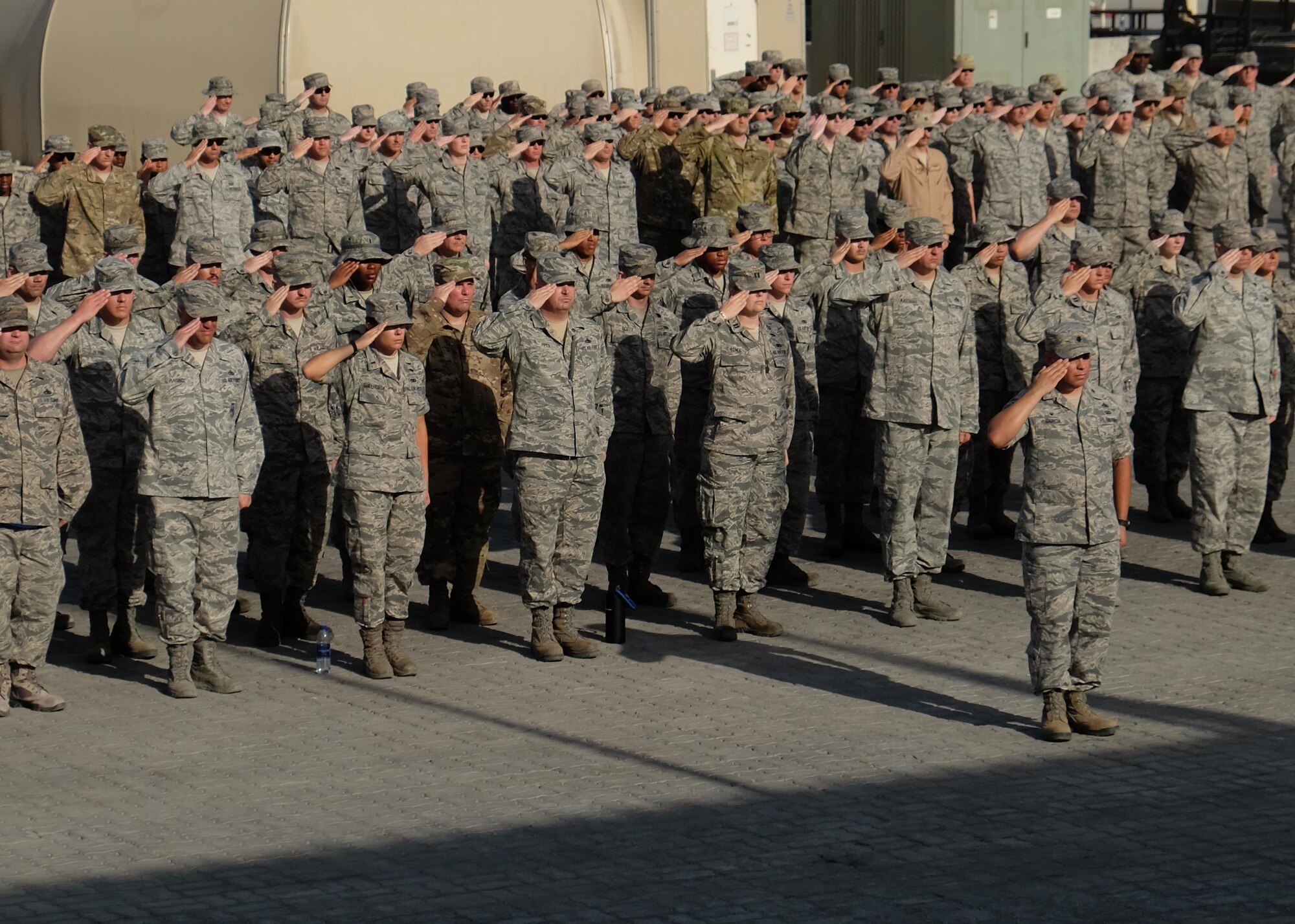 380th Air Expeditionary Wing Airmen salute the U.S. flag as it is lowered during a monthly retreat ceremony June 2, 2017, at an undisclosed location in southwest Asia. Retreat is a long-standing tradition honoring the flag and signaling the end of the duty day. (U.S. Air Force photo by Senior Airman Preston Webb)