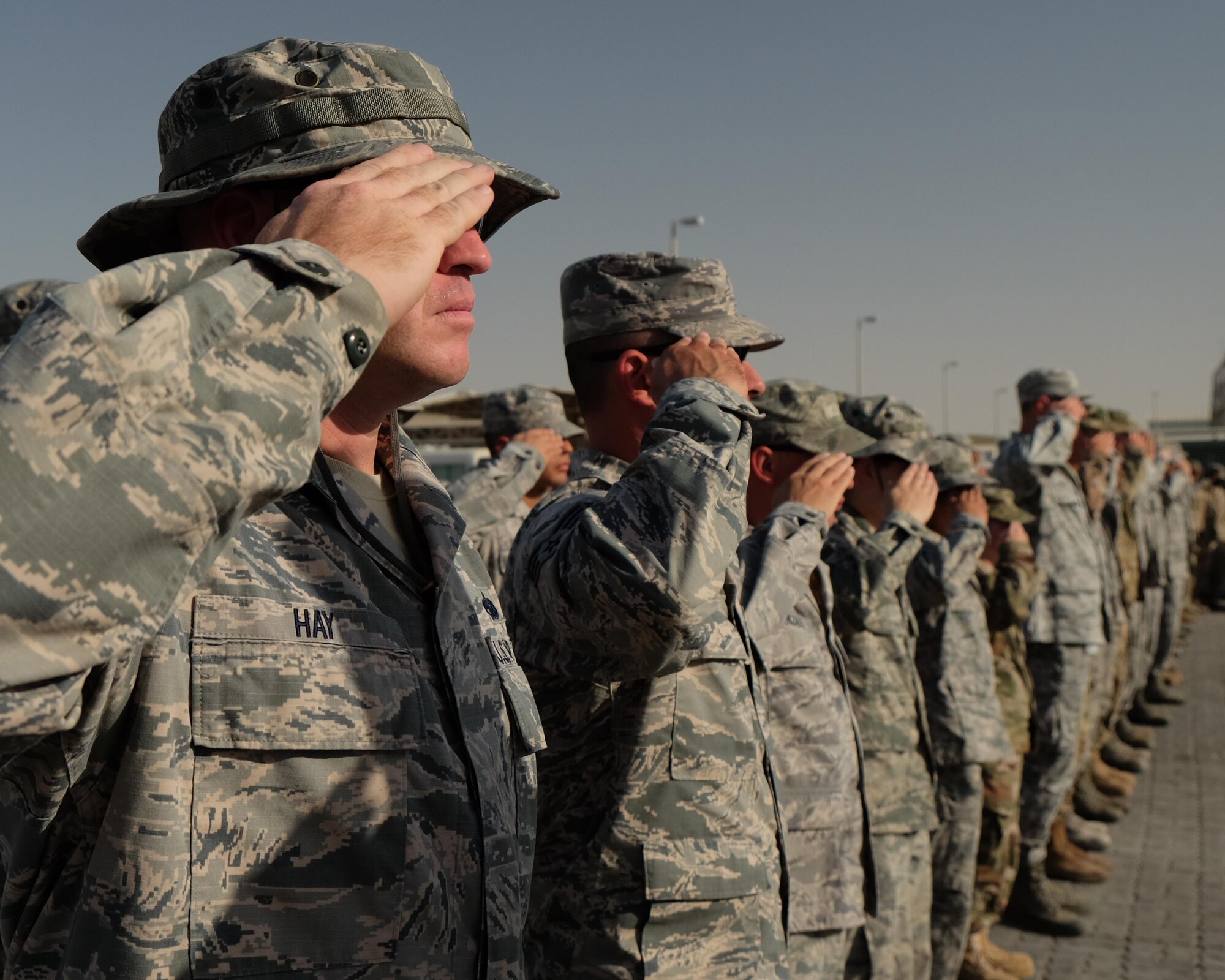 380th Air Expeditionary Wing Airmen salute the U.S. flag as it is lowered during a monthly retreat ceremony June 2, 2017, at an undisclosed location in southwest Asia. Retreat is a long-standing tradition honoring the flag and signaling the end of the duty day. (U.S. Air Force photo by Senior Airman Preston Webb)