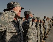 380th Air Expeditionary Wing Airmen salute the U.S. flag as it is lowered during a monthly retreat ceremony June 2, 2017, at an undisclosed location in southwest Asia. Retreat is a long-standing tradition honoring the flag and signaling the end of the duty day. (U.S. Air Force photo by Senior Airman Preston Webb)