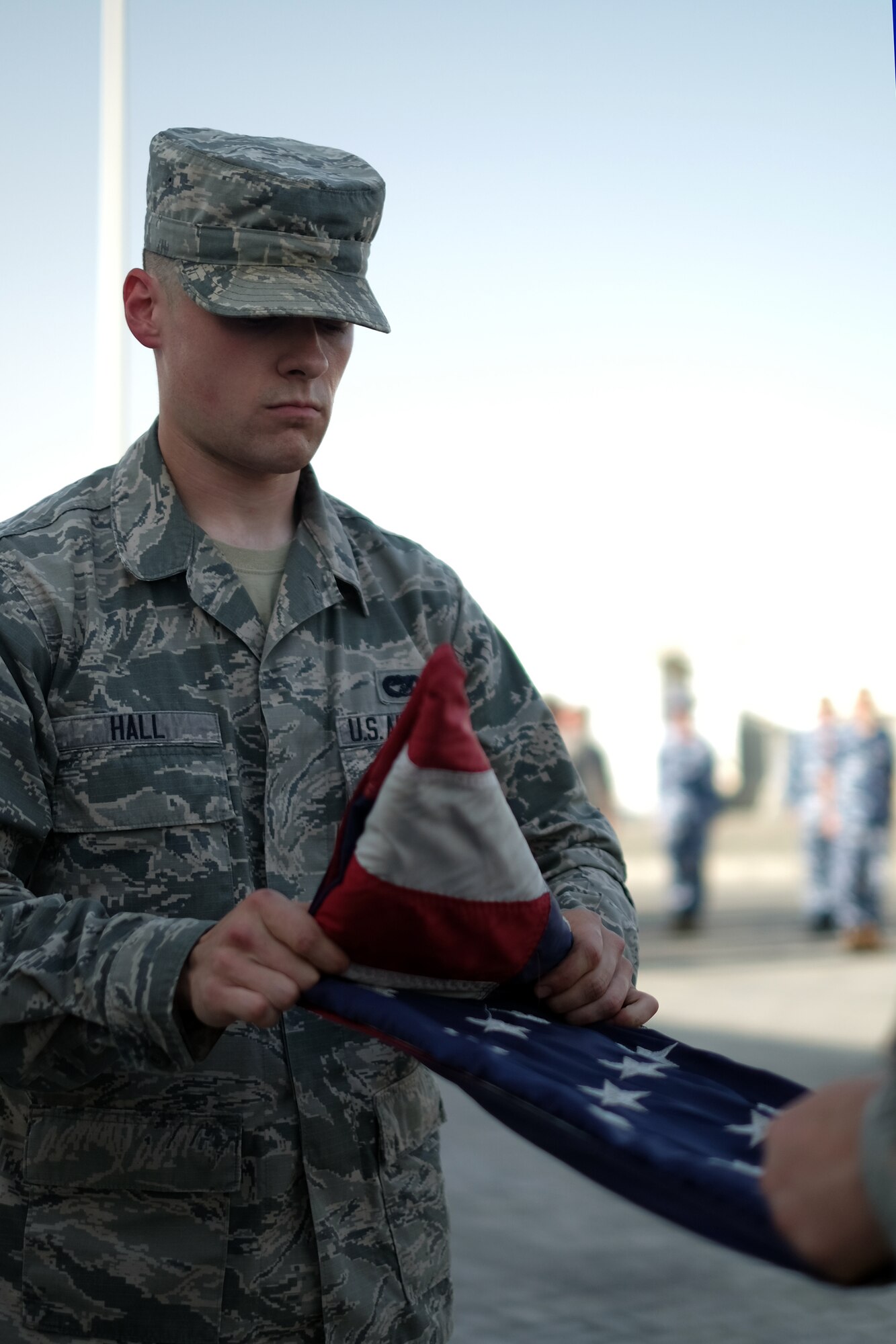 A 380th Air Expeditionary Wing honor guardsman folds the U.S. flag during a monthly retreat ceremony June 2, 2017, at an undisclosed location in southwest Asia. A retreat ceremony, in which the U.S. flag is retired, takes place here on the first Friday of every month. (U.S. Air Force photo by Senior Airman Preston Webb)