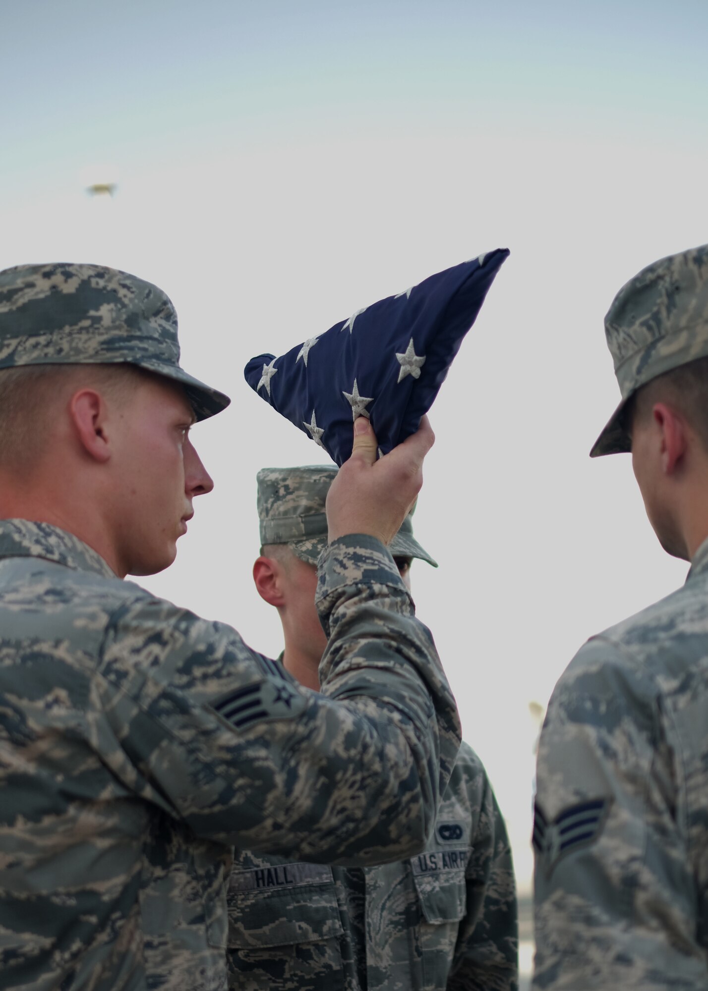 A 380th Air Expeditionary Wing honor guardsman inspects the U.S. flag during a monthly retreat ceremony June 2, 2017, at an undisclosed location in southwest Asia. A retreat ceremony, in which the U.S. flag is retired, takes place here on the first Friday of every month. (U.S. Air Force photo by Senior Airman Preston Webb)