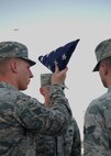 A 380th Air Expeditionary Wing honor guardsman inspects the U.S. flag during a monthly retreat ceremony June 2, 2017, at an undisclosed location in southwest Asia. A retreat ceremony, in which the U.S. flag is retired, takes place here on the first Friday of every month. (U.S. Air Force photo by Senior Airman Preston Webb)