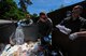 Airmen from the 86th Airlift Wing search and review discarded paperwork in a dumpster for potential improperly disposed critical information during a risk assessment on Ramstein Air Base, May 31, 2017. The 86th AW Operations Security program team and unit coordinators conducted a risk assessment for improperly disposed critical information in order to further educate units on protecting sensitive information. (U.S. Air Force photo by Staff Sgt. Nesha Humes)