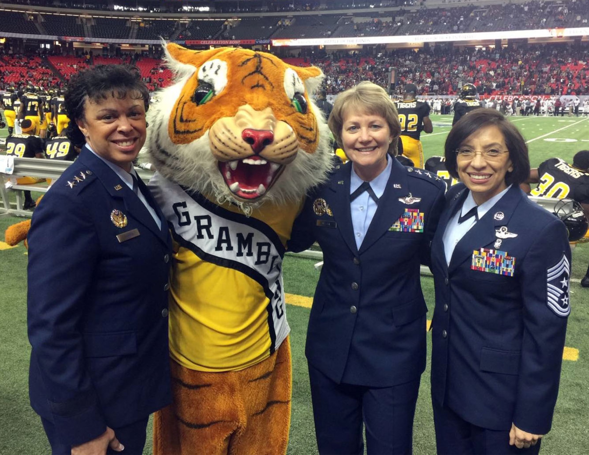 Eddie the Tiger, aka Senior Airman Quincy Wheaton, poses with (left to right) Lt. Gen. Stayce Harris, assistant vice chief of staff and director of the Air Staff, Headquarters Air Force, Washington, D.C.; Lt. Gen, Maryanne Miller, Air Force Reserve Command commander; and Chief Master Sgt. Ericka Kelly, AFRC command chief. (U.S. Air Force photo by Master Sgt. Chance Babin)