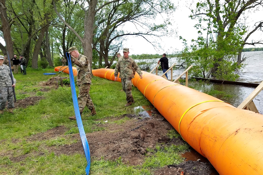 New York Army National Guardsmen set up the Tiger Dam flood control system along the shores of Braddock Bay in Greece, N.Y., June 1, 2017, in response to rising waters on Lake Ontario. Army National Guard photo by Sgt. Lucian McCarty