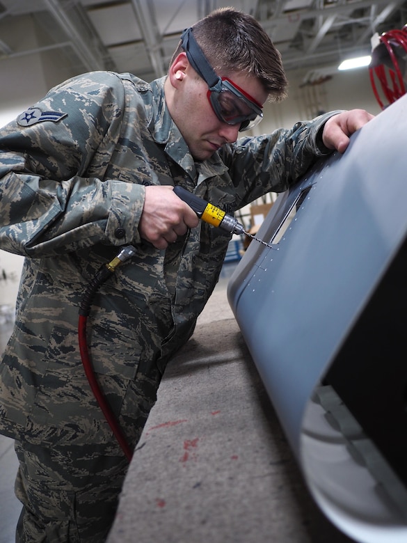 Air Force Airman 1st Class Lukas Johnson, an aircraft structural maintenance technician with the 3rd Aircraft Maintenance Squadron at Joint Base Elmendorf-Richardson, Alaska, works with a C-130 Hercules leading-edge training aid April 20, 2017. The Phoenix native works to prevent aircraft corrosion, which can compromise an aircraft's structure. Air Force photo by David Bedard
