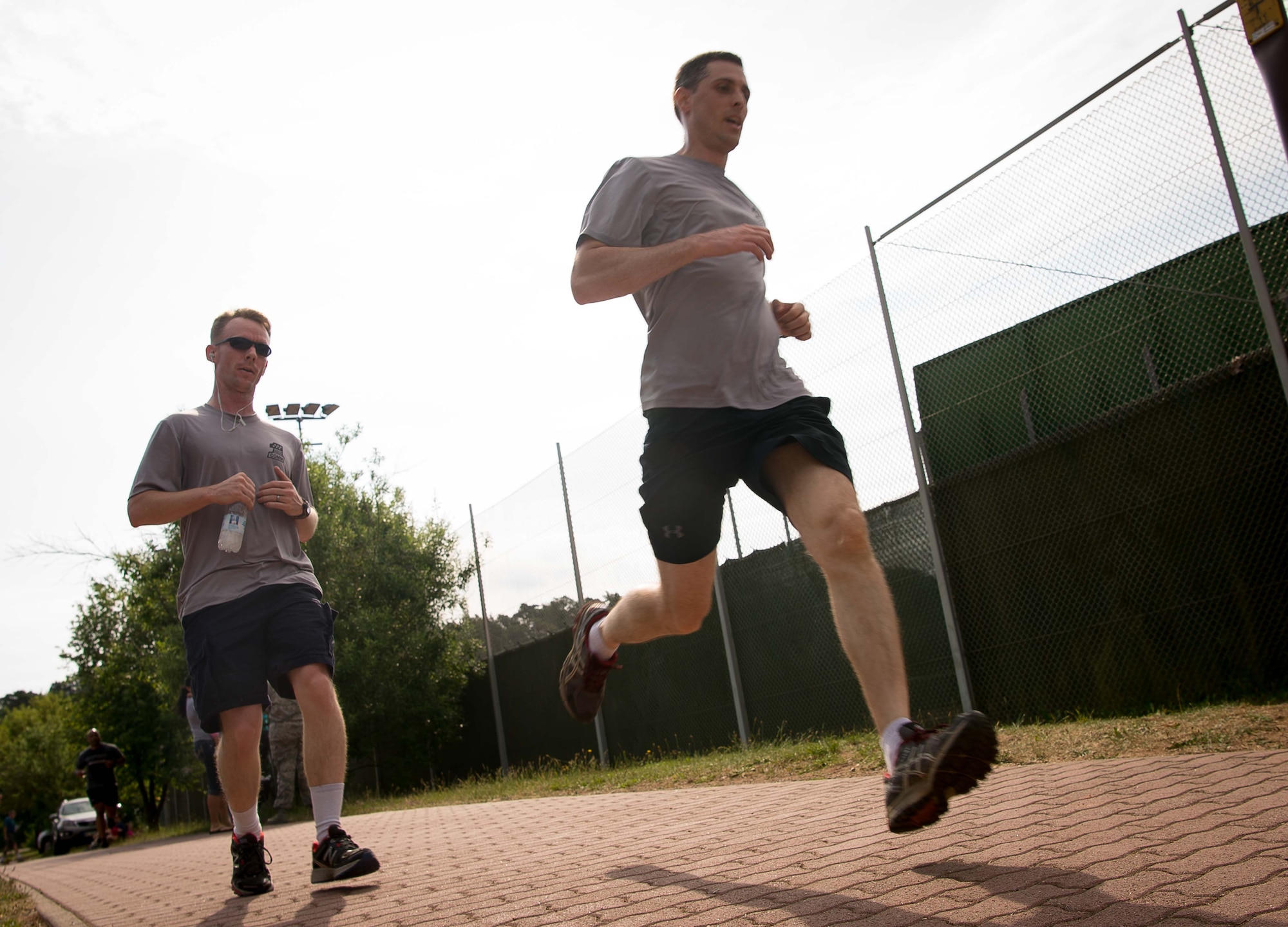 Participants in the Second Annual Chief Master Sgt. of the Air Force Paul Airey Memorial 10K run/walk approach the finish line on Ramstein Air Base, June 2, 2017. Teams and individuals from the Kaiserslautern Military Community area took on the 5K and 10K walk/run and the 10K ruck march challenge in remembrance of the first Chief Master Sgt. of the Air Force, Paul Airey, who survived a 400 mile march as a prisoner of war in Germany during World War II. (U.S. Air Force photo by Airman 1st Class Elizabeth Baker)