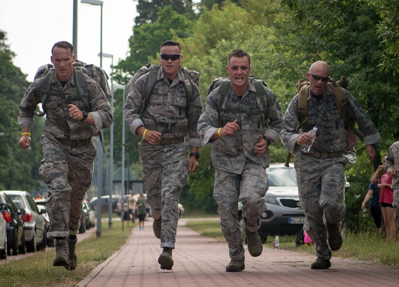 The winners of the Second Annual Chief Master Sgt. of the Air Force Paul Airey Memorial 10K ruck, charge for the finish line at Ramstein Air Base, June 2, 2017. Teams from various squadrons in the Kaiserslautern military community area took on the 10K ruck march challenge. Participants were allowed to walk or run but they had to be in uniform and carry 25lb rucks, or backpacks, from start to finish. (U.S. Air Force photoby Airman 1st Class Elizabeth Baker)
