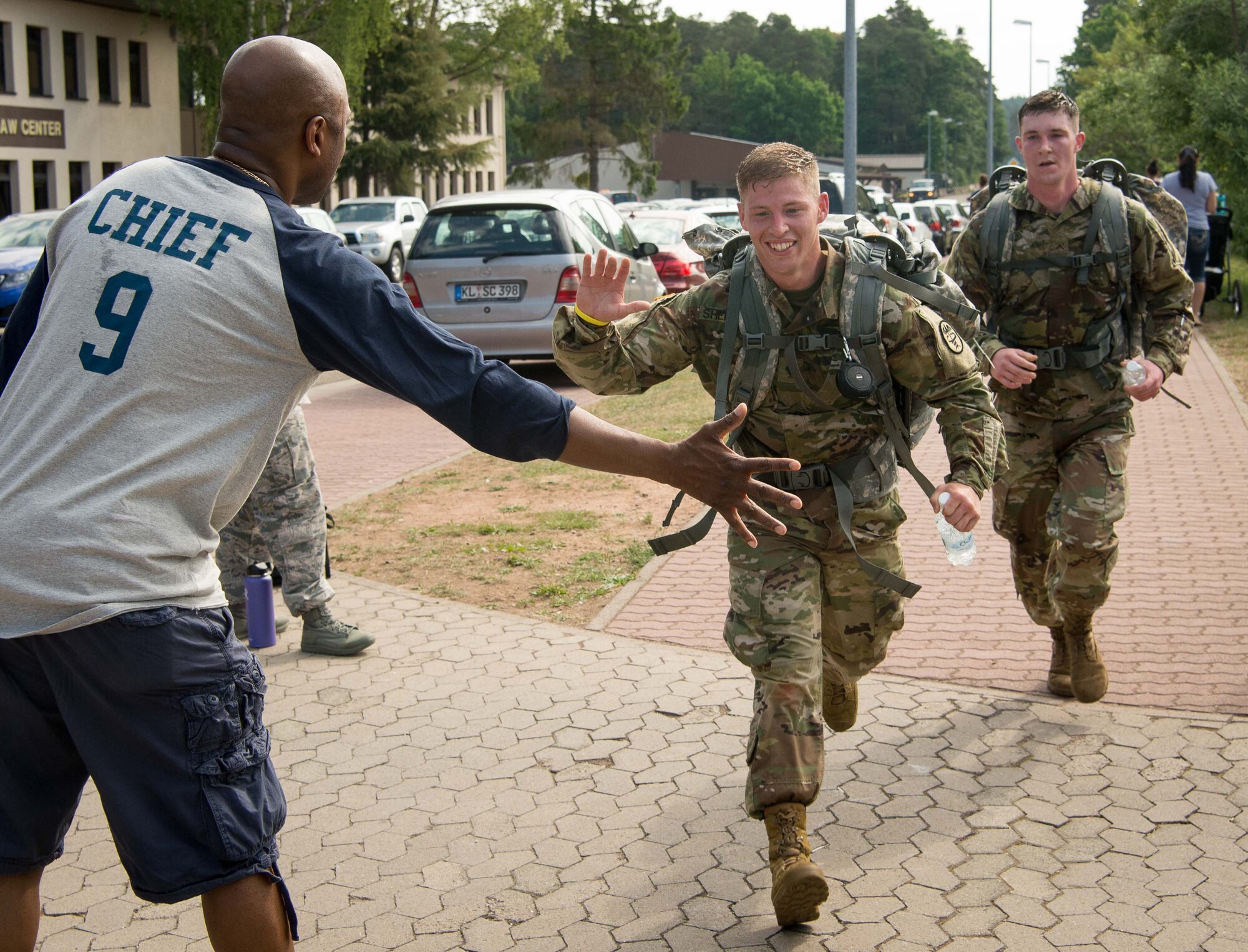 Participants of the Second Annual Chief Master Sgt. of the Air Force Paul Airey Memorial 10K ruck, cross the finish line on Ramstein Air Base, June 2, 2017. Sponsored by the Ramstein Chiefs Group, the annual memorial events were established to honor the first Chief Master Sgt. of the Air Force, Paul Airey, who survived a 400 mile march as a prisoner of war in Germany during World War II. (U.S. Air Force photo by Airman 1st Class Elizabeth Baker)