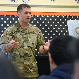 Capt. Jordan Branco, Headquarters and Headquarters Battalion, U.S. Army South, talks to a sixth-grade class at Booker T. Washington Elementary School about his job as a Soldier during the school’s career day May 26. The school and unit are partnered through the Adopt-a-School program. Units on JBSA-Fort Sam Houston are partnered with schools with the Northeast Independent School District, the San Antonio Independent School District and the Fort Sam Houston Independent School District. Throughout the year, Soldiers partner with their designated school and provide mentorship to students as well as assist with career days, field trips and many other activities. 