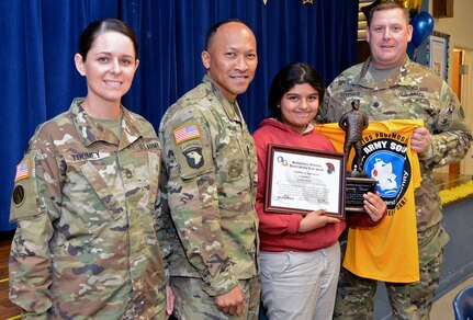 Leadership from Headquarters and Headquarters Battalion presented the Citizenship Award to Booker T. Washington Elementary School student Maria Ross May 31. The school is partnered with the unit as part of the Adopt-a-School program. The Citizenship Award is an honor that goes to the student that demonstrates the Army Values and is a good citizen, not only in her school, but in her community as well. The school staff elects the recipient. 