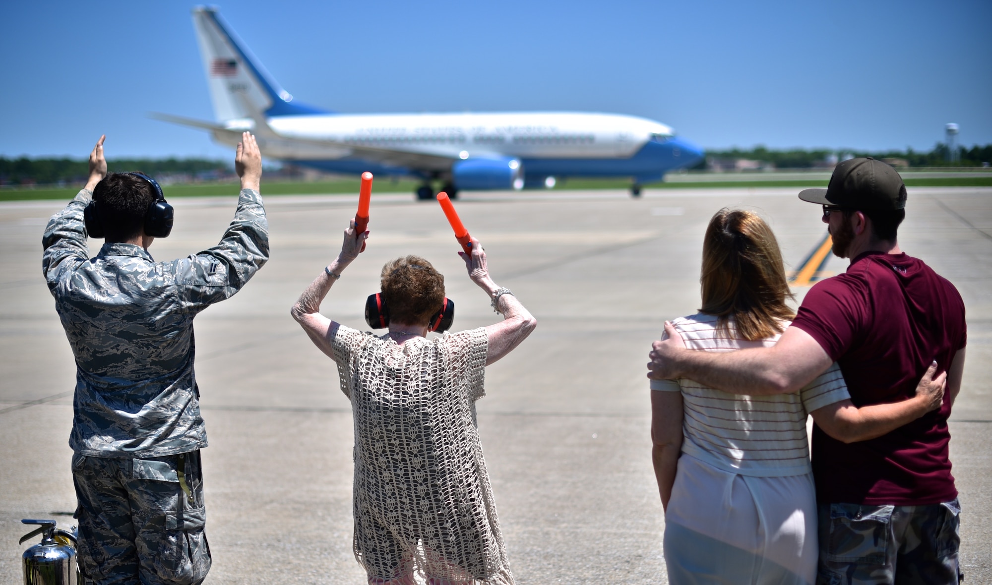 Rosalie Philebaum marshals in her son, 932nd AW commander, Jonathan Philebaum during his fini flight with help from Airman 1st Class Zachary Keeven, 932nd Airlift Wing crew chief, May 31, 2017, Scott Air Force Base, Illinois.  Philebaum's wife and son also joined in the ceremonial fun. (U.S. Air Force photo by Christopher Parr)