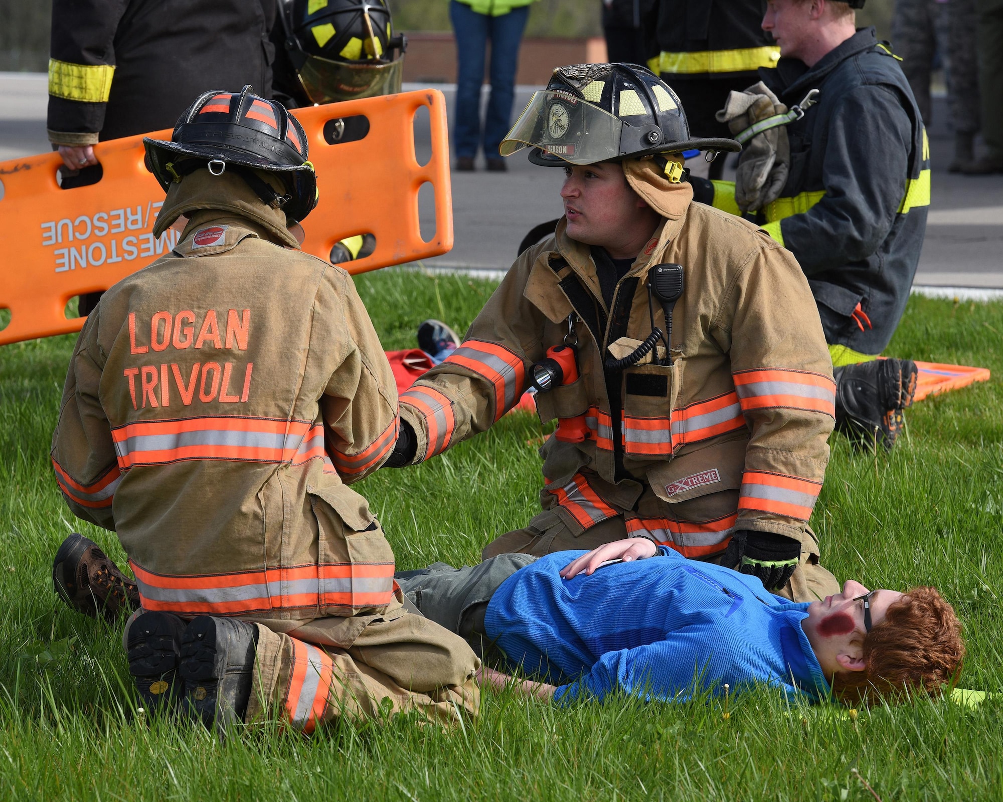 Firefighters from Logan-Trivoli Fire Protection District evaluate the condition of Joshua Palinkas, a senior patrol leader of Boy Scout Troop 88, who is playing the role of a victim of a simulated aircraft crash at the General Wayne A. Downing Peoria International Airport in Peoria, Ill. April 22, 2017.  Thirty-eight agencies and more than 200 exercise participants took part in the full-scale mass casualty exercise. (U.S. Air National Guard photo by Master Sgt. Todd Pendleton)