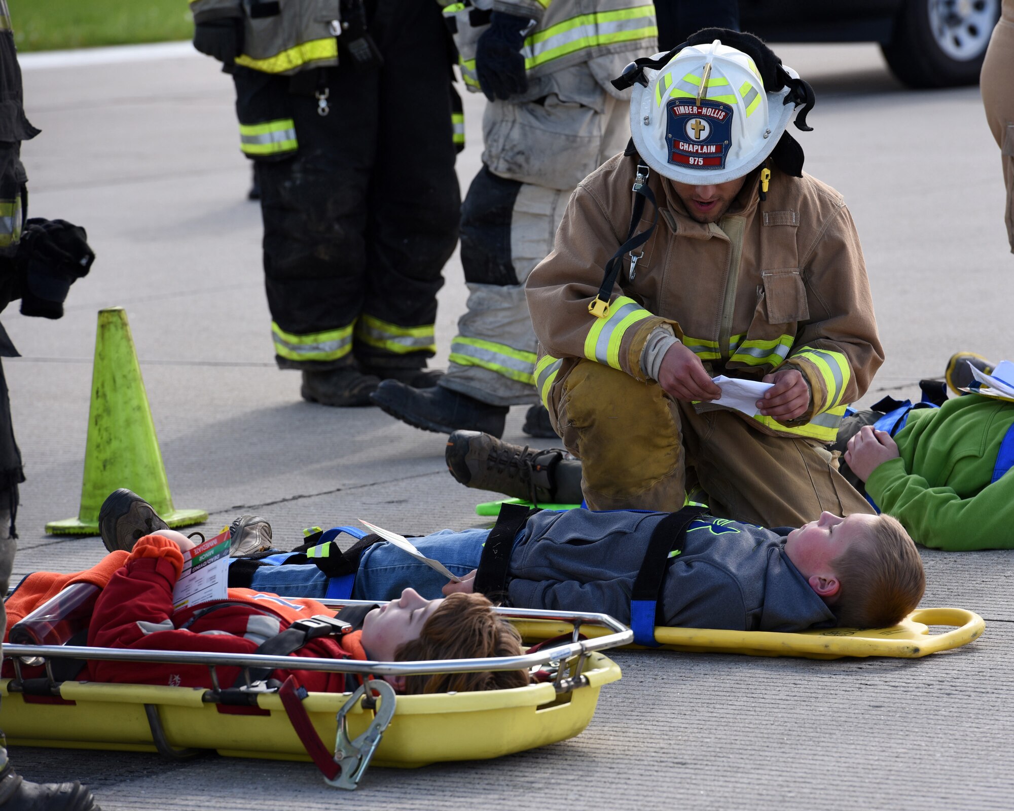 Pastor Ethan Carnes, a firefighter and chaplain with the Timber-Hollis Fire Protection District evaluates the condition of two Boy Scouts who are playing the roles of victims of an aircraft crash at the General Wayne A. Downing Peoria International Airport in Peoria, Ill. April 22, 2017. Thirty-eight agencies and more than 200 exercise participants took part in the full-scale mass casualty exercise. (U.S. Air National Guard photo by Master Sgt. Todd Pendleton)