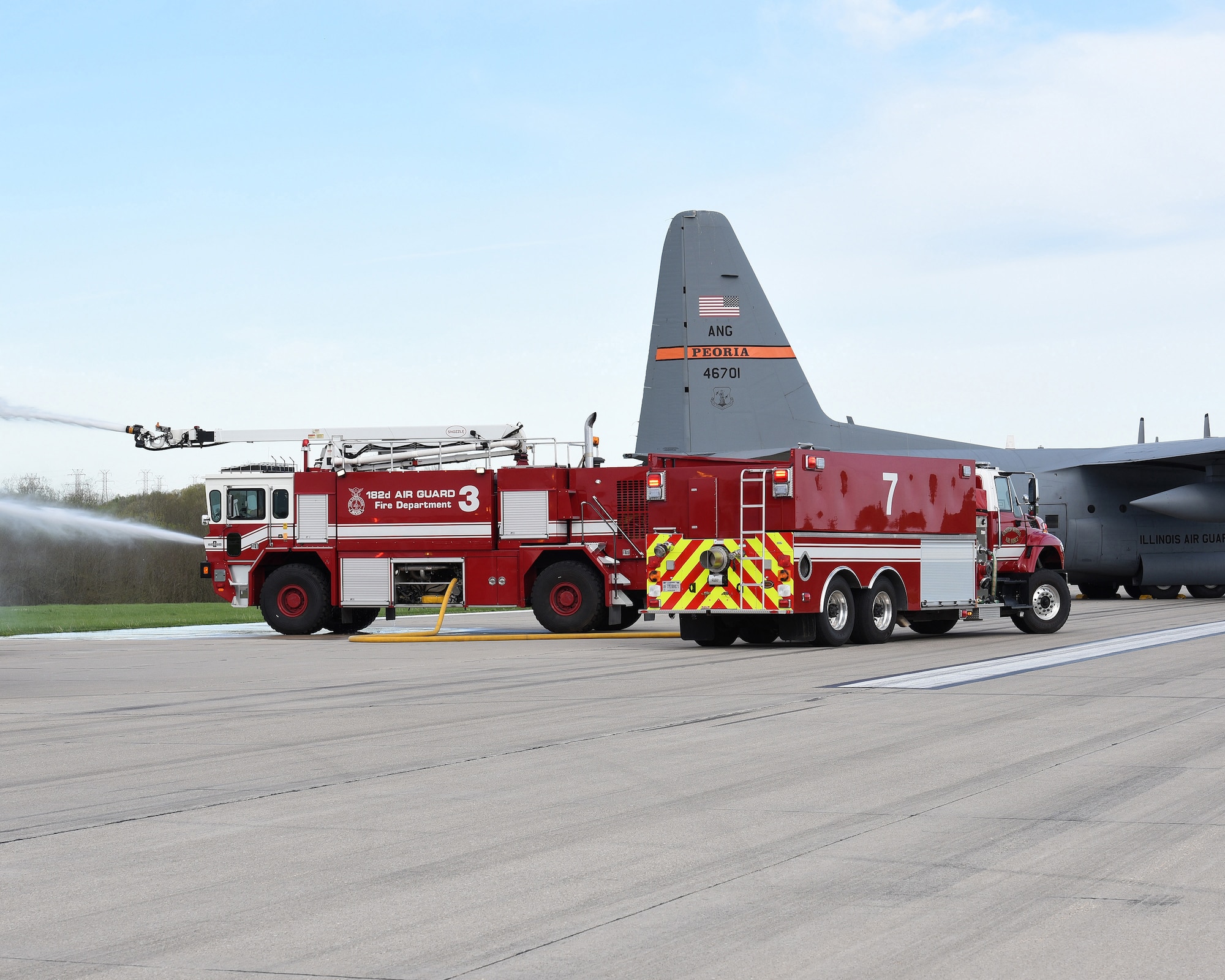 A water tender truck supplies water to an Oshkosh T1500 crash truck while simulating extinguishing a fire during an exercise at the General Wayne A. Downing Peoria International Airport in Peoria, Ill. April 22, 2017. Thirty-eight agencies and more than 200 exercise participants took part in the full-scale mass casualty exercise. (U.S. Air National Guard photo by Master Sgt. Todd Pendleton)