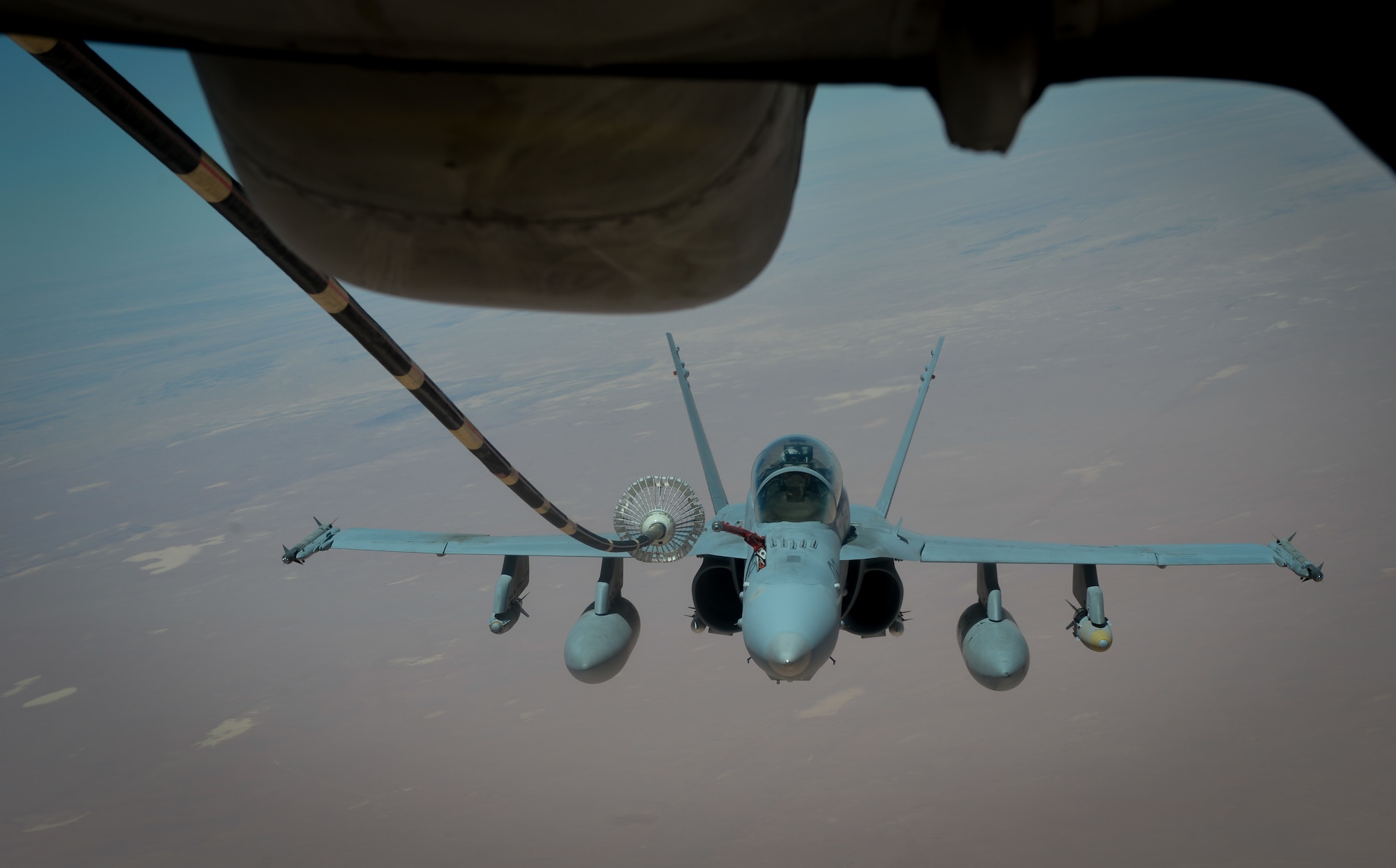 A U.S. Marine Corps F-18 Super Hornet receives fuel from a 908th Expeditionary Air Refueling Squadron KC-10 Extender during a flight in support of Operation Inherent Resolve May 31, 2017. The Super Hornet is capable across the full mission spectrum: air superiority, fighter escort, reconnaissance, aerial refueling, close air support, air defense suppression and day and night precision strike. (U.S. Air Force photo by Staff Sgt. Michael Battles)