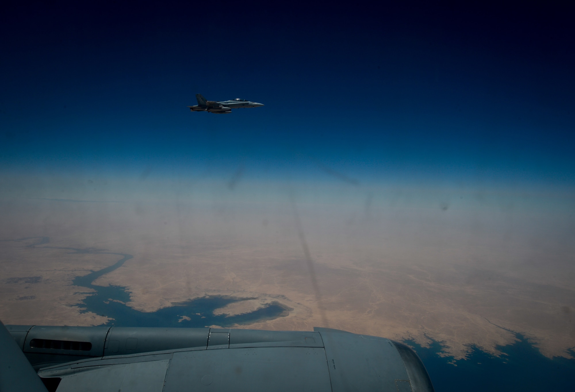 A U.S. Marine Corps F-18 Super Hornet departs after receiving fuel from a 908th Expeditionary Air Refueling Squadron KC-10 Extender during a flight in support of Operation Inherent Resolve May 31, 2017. The Super Hornet is capable across the full mission spectrum: air superiority, fighter escort, reconnaissance, aerial refueling, close air support, air defense suppression and day and night precision strike. (U.S. Air Force photo by Staff Sgt. Michael Battles)