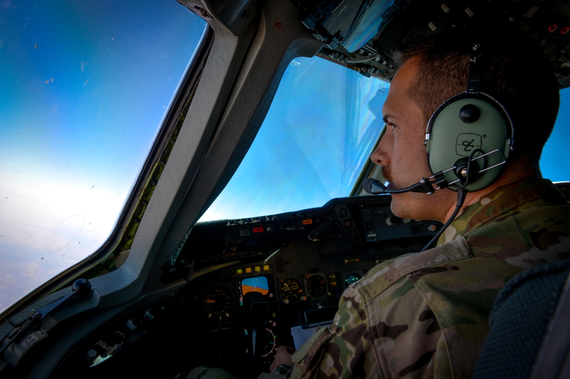 A 908th Expeditionary Air Refueling Squadron KC-10 Extender pilot speaks with the crew during a flight in support of Operation Inherent Resolve May 31, 2017. The KC-10 is an Air Mobility Command advanced tanker and cargo aircraft designed to provide increased global mobility for U.S. Armed Forces. The KC-10's primary mission is aerial refueling; it can combine the tasks of a tanker and cargo aircraft by refueling fighters and simultaneously carry the fighter support personnel and equipment on overseas deployments. (U.S. Air Force photo by Staff Sgt. Michael Battles)