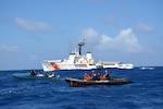 A Coast Guard Cutter Diligence pursuit team interdicts a "go-fast" boat suspected of smuggling illegal drugs. From left to right in the in the "go-fast" is Lt. j.g. Edward Hobaica, and Petty Officer 2nd Class Jussen Gonzales, while from left to right on the Coast Guard response boat is Petty Officer 2nd Class Anthony Sanabria, Petty Officer 2nd Class Charles Murray and Petty Officer 1st Class Adam Mallard. (U.S. Coast Guard photo by Cutter Diligence/Released)