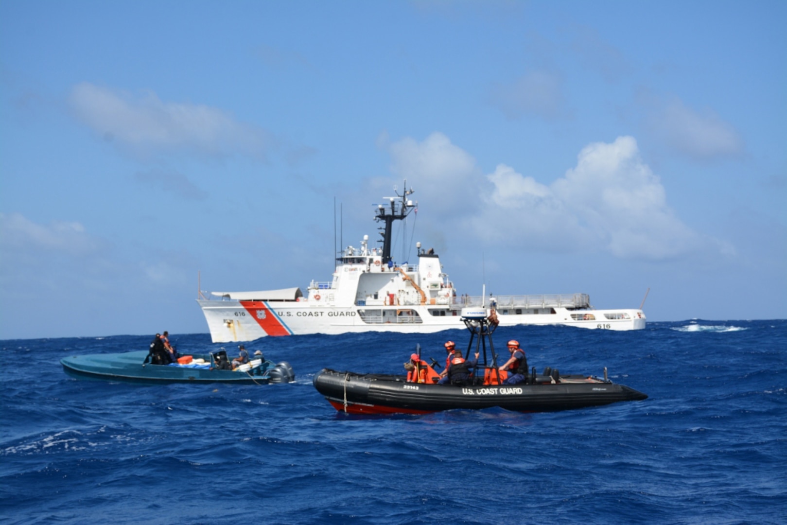 A Coast Guard Cutter Diligence pursuit team interdicts a "go-fast" boat suspected of smuggling illegal drugs. From left to right in the in the "go-fast" is Lt. j.g. Edward Hobaica, and Petty Officer 2nd Class Jussen Gonzales, while from left to right on the Coast Guard response boat is Petty Officer 2nd Class Anthony Sanabria, Petty Officer 2nd Class Charles Murray and Petty Officer 1st Class Adam Mallard. (U.S. Coast Guard photo by Cutter Diligence/Released)