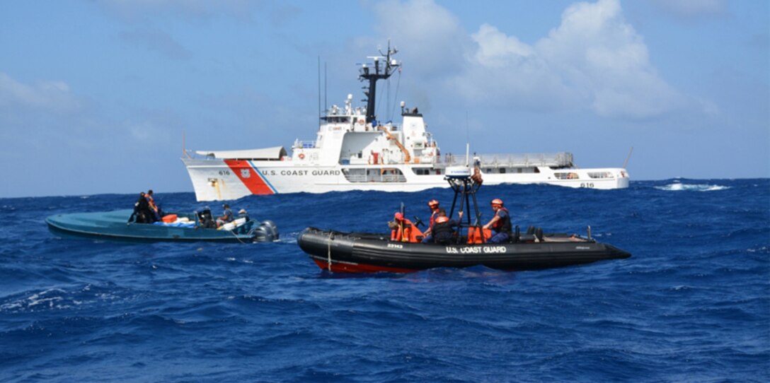 A Coast Guard Cutter Diligence pursuit team interdicts a "go-fast" boat suspected of smuggling illegal drugs. From left to right in the in the "go-fast" is Lt. j.g. Edward Hobaica, and Petty Officer 2nd Class Jussen Gonzales, while from left to right on the Coast Guard response boat is Petty Officer 2nd Class Anthony Sanabria, Petty Officer 2nd Class Charles Murray and Petty Officer 1st Class Adam Mallard. (U.S. Coast Guard photo by Cutter Diligence/Released) 