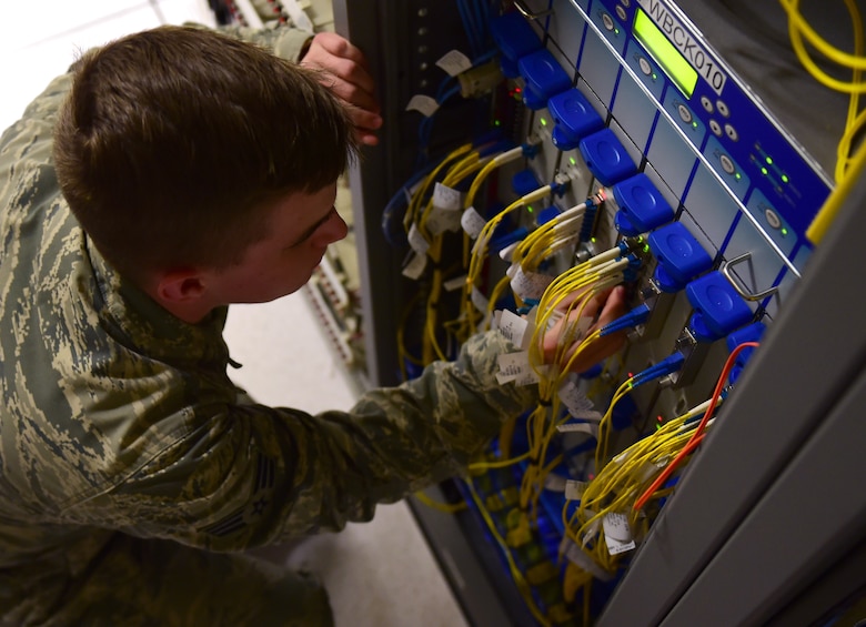 Senior Airman Clayton Traugott, 460th Space Communication Squadron circuit actions technician, operates on a circuit box March 15, 2017, on Buckley Air Force Base, Colo. Circuit actions technicians coordinate, install, maintain and troubleshoot Defense Information Systems Agency directed circuits that connects Air Force Space Command users. (U.S. Air Force photo by Airman Jacob Deatherage/Released)