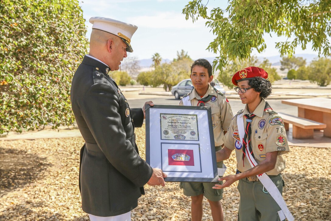 Boy Scouts from Lodge #127 Order of the Arrow present Combat Center Commanding General Brig. Gen. William F. Mullen III with an award after the Memorial Day service at the Twentynine Palms cemetery, Twentynine Palms, Calif., May 30, 2017. Mullen was recognized by the Lodge for his outstanding contributions to the community.