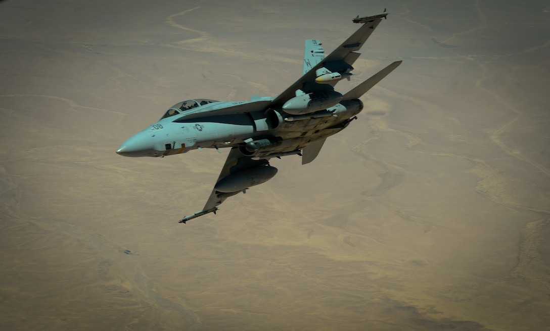 A U.S. Marine Corps F-18 Super Hornet departs after receiving fuel from a 908th Expeditionary Air Refueling Squadron KC-10 Extender during a flight in support of Operation Inherent Resolve May 31, 2017. The Super Hornet is capable across the full mission spectrum: air superiority, fighter escort, reconnaissance, aerial refueling, close air support, air defense suppression and day and night precision strike. (U.S. Air Force photo by Staff Sgt. Michael Battles)