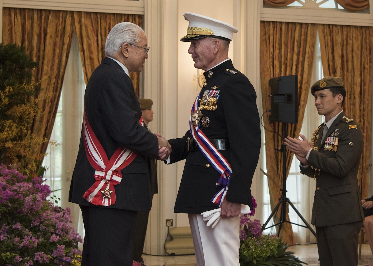 Marine Corps Gen. Joe Dunford, chairman of the Joint Chiefs of Staff, speaks with Singaporean President Tony Tan after receiving Singapore's Military Distinguished Service Order medal in Newton, Singapore, June 2, 2017. Dunford is in Singapore to attend the Shangri-La Dialogue, an Asia-focused defense summit, where he will meet with regional allies and counterparts to discuss common security issues. DoD photo by Navy Petty Officer 2nd Class Dominique A. Pineiro