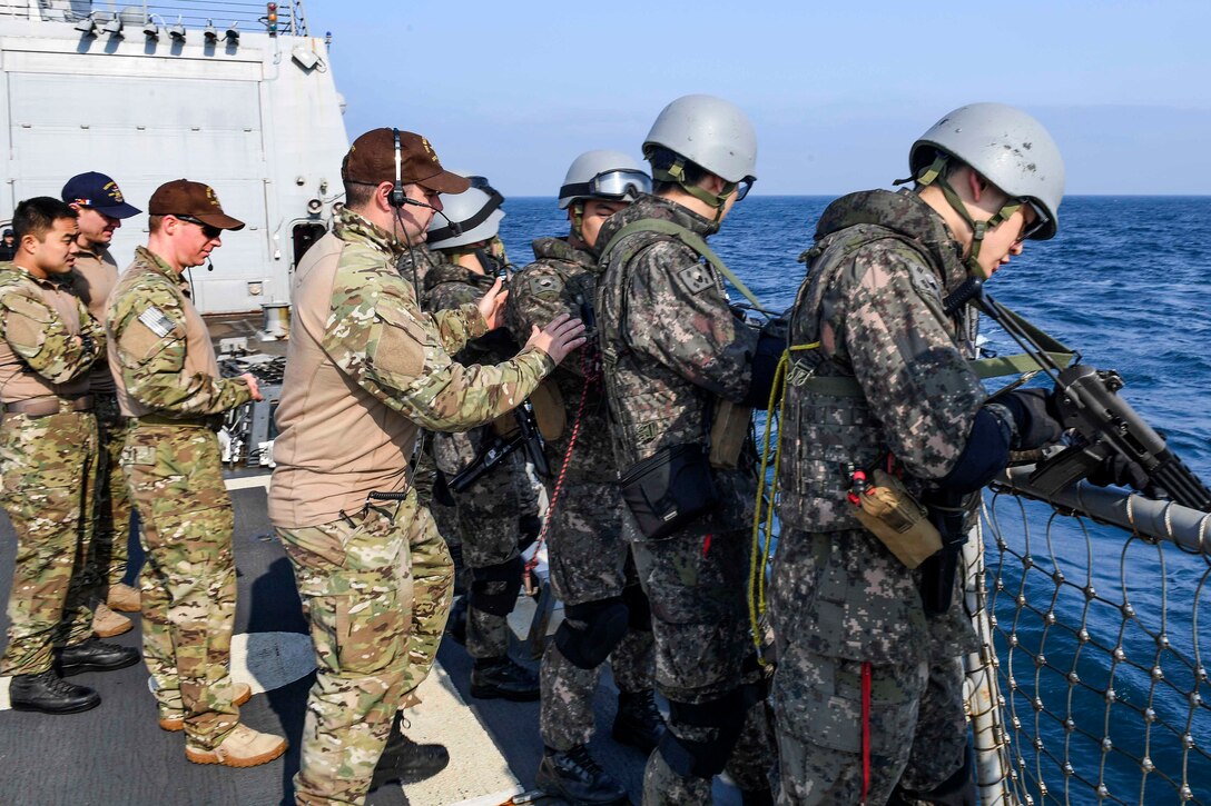 U.S. sailors, left, verify that South Korean sailors' rifles are clear and safe during training aboard the USS Wayne E. Meyer in the western Pacific Ocean, May 22, 2017. The U.S. sailors are members of a visit, board, search and seizure team. Navy photo by Petty Officer 3rd Class Kelsey L. Adams