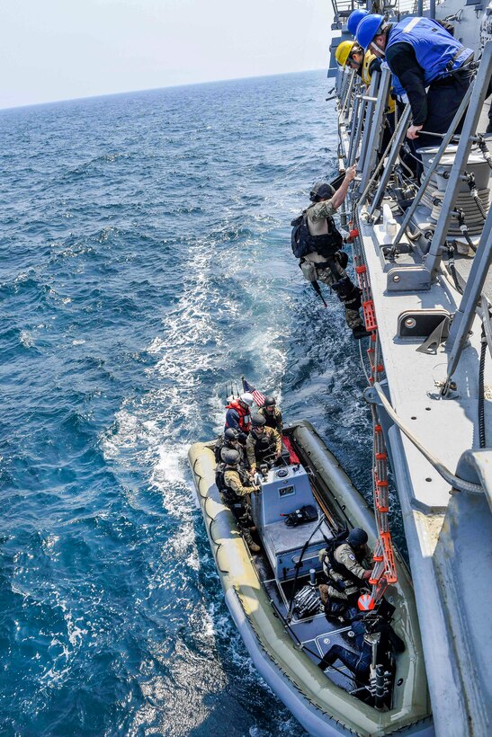 U.S. sailors use a ladder to descend from the USS Wayne E. Meyer into a rigid-hull inflatable boat during visit, board, search and seizure training in the western Pacific Ocean, May 22, 2017. Navy photo by Petty Officer 3rd Class Kelsey L. Adams