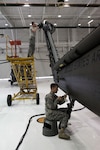U.S. Army Spc. Mark Heintz and Spc. Kyle Pfeifle, general mechanics with the South Dakota Army National Guard’s Detachment 1, Company B, 935th Aviation Support Battalion, disassemble and inspect an HH-60 Black Hawk helicopter at the SDARNG aviation facility in Rapid City, S.D., March 25, 2017. Members of the 935th perform general repairs and inspections periodically to ensure the aircrafts are safe to operate. 