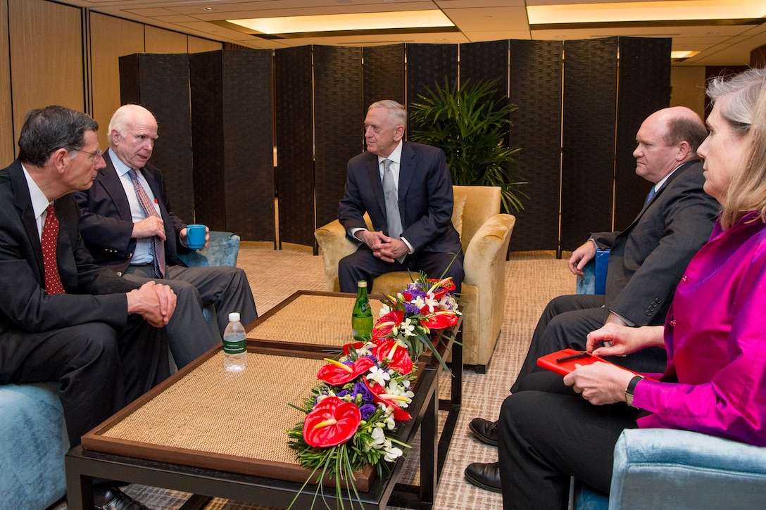 Defense Secretary Jim Mattis meets with U.S. Sen. John McCain during the Shangri-La Dialogue in Singapore.
