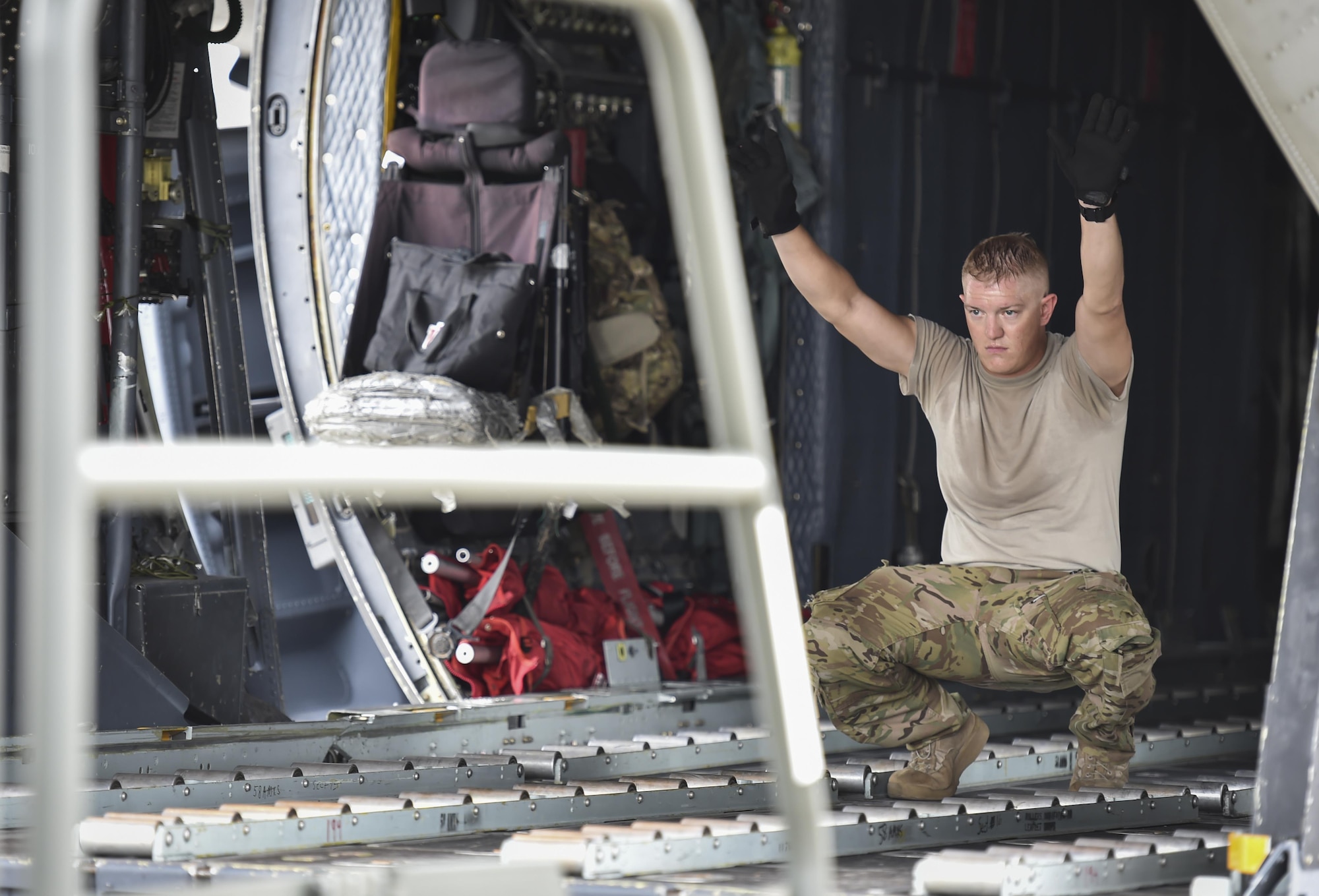 Staff Sgt. Josh Kindell, a loadmaster with the 15th Special Operations Squadron, guides a cargo loader onto an MC-130H Combat Talon II at Hurlburt Field, Fla., May 30, 2017. Loadmasters loaded the Combat Talon with cargo to drop in flight for a training mission to ensure their precision global reach capability. (U.S. Air Force photo by Airman 1st Class Joseph Pick)