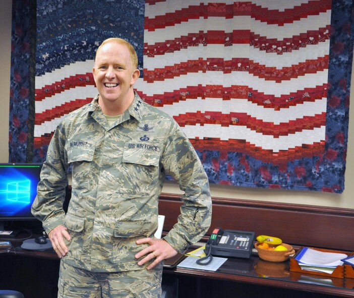 On May 24 in his Wright-Patterson Air Force Base office, Lt.Gen Robert D.McMurry, commander of the Air Force Life Cycle Management Center, stands in front of the American flag quilt his wife, De, made in memory of 9/11. McMurry took command of the single center responsible for total life cycle management covering all aircraft, engines, munitions and electronic systems on May 2. (U.S.Air Force photo/Brian Brackens)

