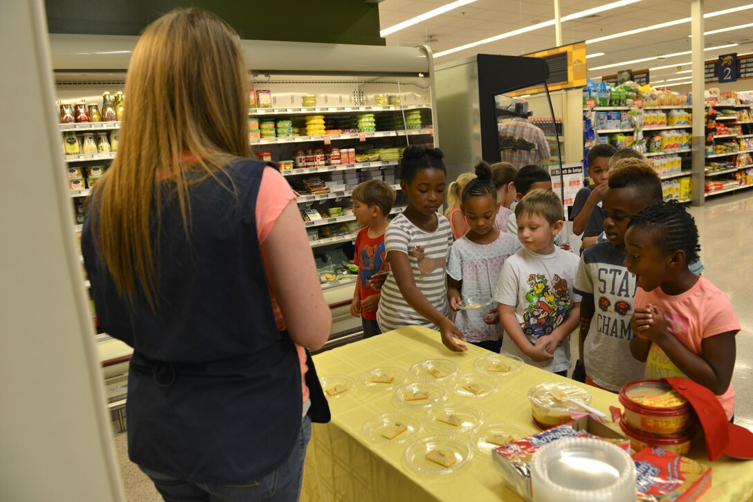 Team Shaw children from the 20th Force Support Squadron Youth Center try hummus during the 2017 Healthy Lifestyle Festival at the Shaw Air Force Base, S.C. Commissary, June 2, 2017. The Shaw Commissary hosted the festival to encourage fitness and nutrition with events such as a 5k run, watermelon eating contest and a healthy snack taste testing. (U.S. Air Force photo by Airman 1st Class Destinee Sweeney)