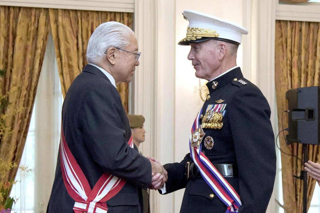 Marine Corps Gen. Joe Dunford, chairman of the Joint Chiefs of Staff, shakes hands with Singapore President Tony Tan Keng Yam after receiving an award at the Istana, Singapore, June 2, 2017. Dunford is in Singapore to attend the Shangri-La Dialogue, an Asia-focused defense summit. DoD photo by Navy Petty Officer 2nd Class Dominique A. Pineiro