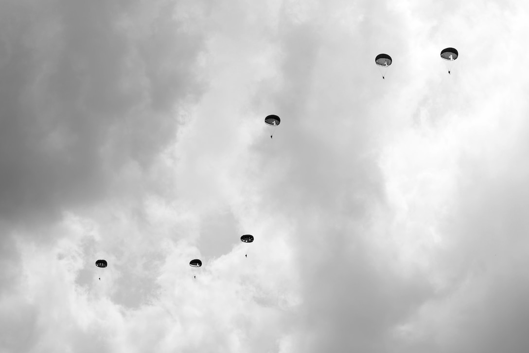 D-Day historical re-enactors conduct a parachute drop from a vintage C-47 Skytrain in Carentan, France, June 2, 2017. DoD photo by Chief Petty Officer John M. Hageman