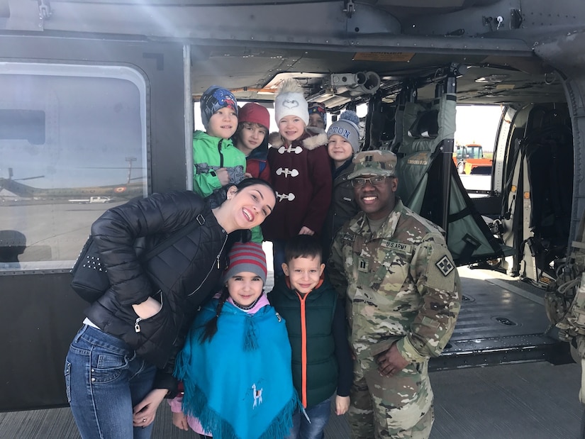 Capt. Jordan Rusher, a signal officer, 926th Engineer Brigade, poses with the local youth, May, 26, 2017. The event included static displays of military vehicles, including tanks, helicopters and Romanian jets. Cpt. Rusher's attendance advances the efforts of Resolute Castle 2017 in support of Operation Atlantic Resolve. Resolute Castle 17 is an exercise strengthening the NATO alliance and enhancing its capacity for joint training and response to threats within the region.