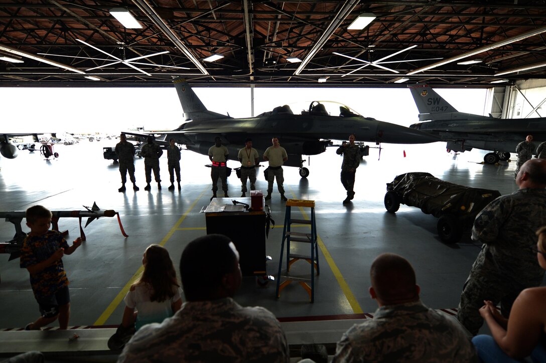 U.S. Airmen assigned to the 20th Aircraft Maintenance Squadron wait for the commencement of the annual Weapons Load Crew of the Year competition at Shaw Air Force Base, S.C., May 31, 2017. Prior to the competition, load crew members undergo a uniform inspection and written test on job-specific tasks to earn points towards their overall team score. (U.S. Air Force photo by Airman 1st Class Christopher Maldonado)