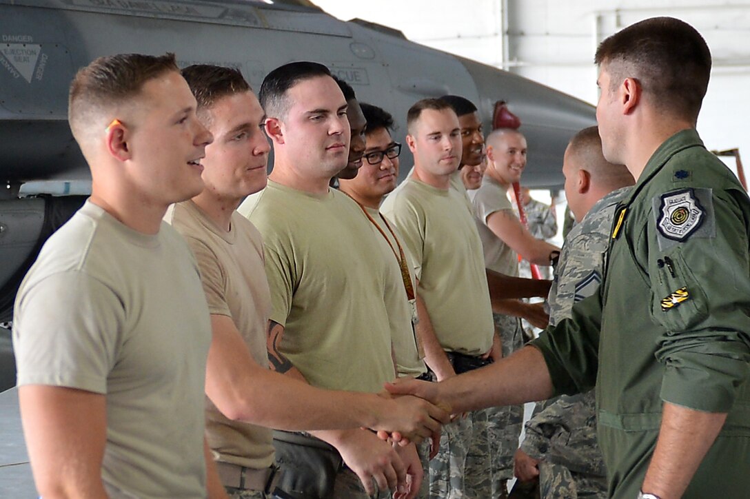 Base leadership congratulate U.S. Airmen assigned to the 20th Aircraft Maintenance Squadron upon completion of the annual Weapons Load Crew of the Year competition at Shaw Air Force Base, S.C., May 31, 2017. The winner of the competition is scheduled to be announced on June 2, 2017 during the maintenance professional of the year ceremony. (U.S. Air Force photo by Airman 1st Class Christopher Maldonado)