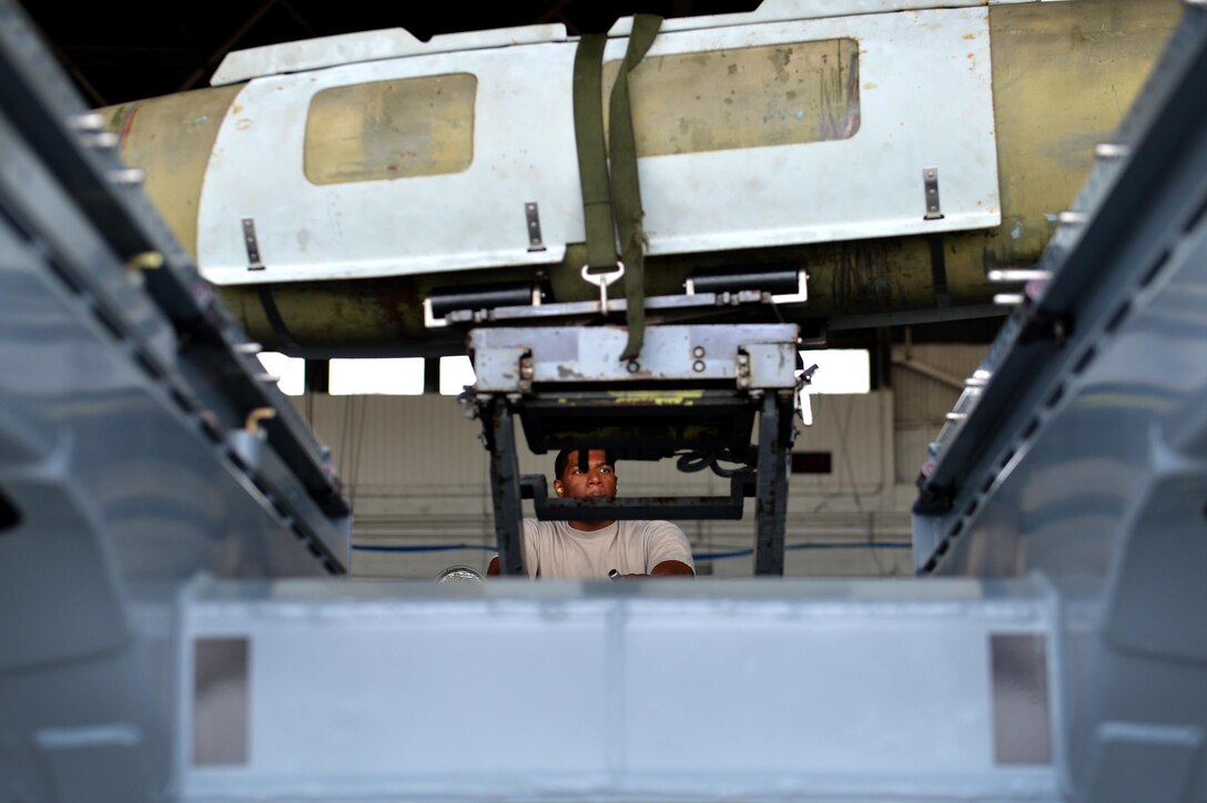 U.S. Air Force Senior Airman Travis Jones, 20th Aircraft Maintenance Squadron weapons load crew member, uses a bomb loader to carry a GBU-31 version one bomb during the annual Weapons Load Crew of the Year competition at Shaw Air Force Base, S.C., May 31, 2017. Load crews, comprised of three Airmen, raced against the clock and tried to beat the current record time of 25 minutes. Airmen had to load a GBU-31, AIM-9M and AIM-9X Sidewinder missile, as well as the M61A1 Vulcan 20 mm rotary cannon quickly in efficiently to gain points towards victory. (U.S. Air Force photo by Airman 1st Class Christopher Maldonado)