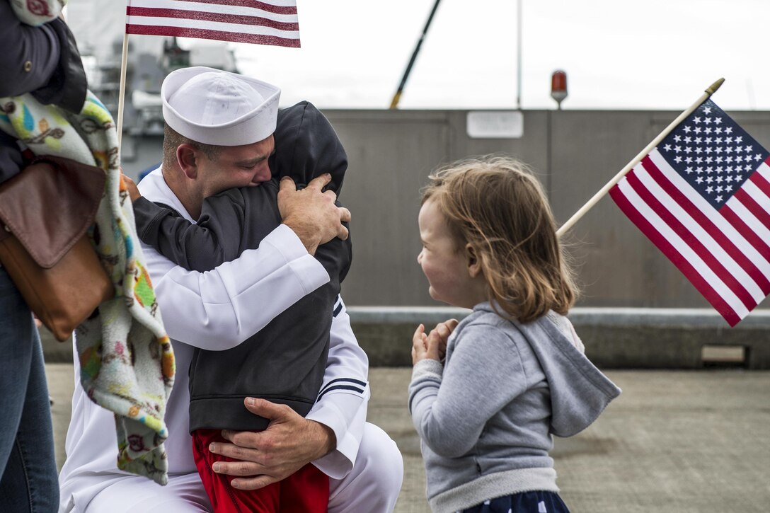 A sailor embraces a family member before departing on the guided missile destroyer USS Shoup in Everett, Wash., June 1, 2017. The Shoup is on a regularly scheduled deployment to the Western Pacific and Indian Oceans as part of the Nimitz Carrier Strike Group. Navy photo by Petty Officer 2nd Class Alex Van’tLeven