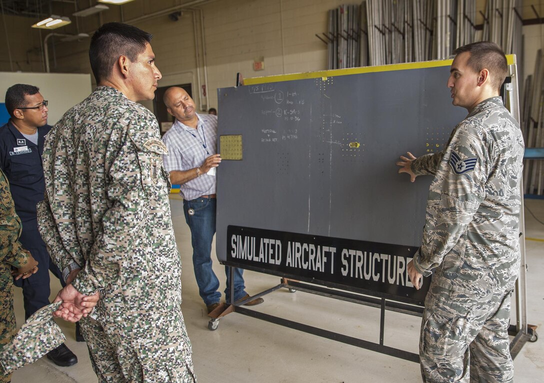 Staff Sgt. Kenan Torrance, 433rd Aircraft Maintenance Squadron sheet metal technician, explains the different repairs that are performed on the C-5M Super Galaxy aircraft to students from the Inter-American Air Force Academy June 1, 2017 at Joint Base San Antonio-Lackland, Texas. The students also visited the fabrication and jet propulsion shops.  (U.S. Air Force photo by Benjamin Faske)