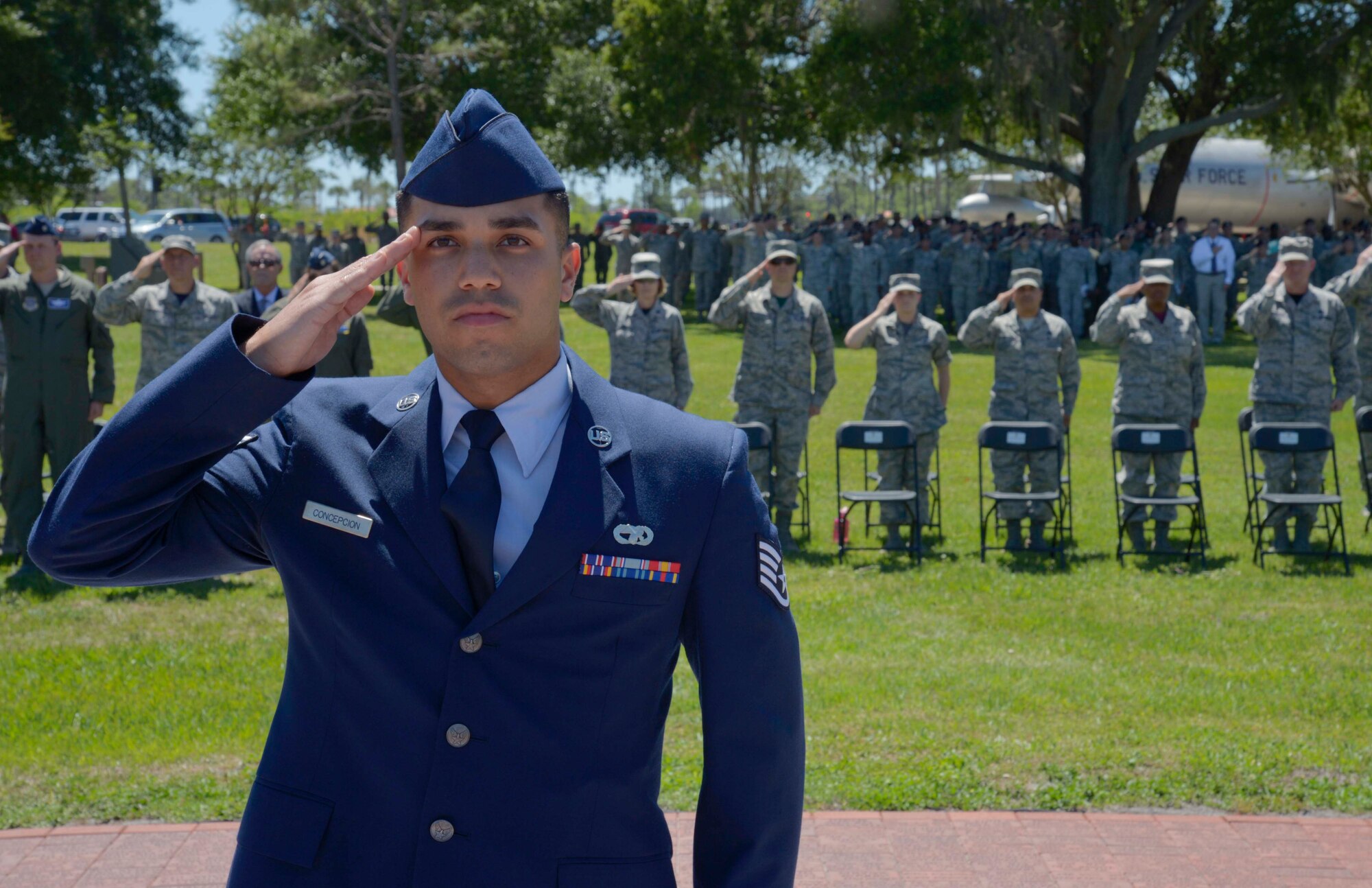 U.S. Air Force Staff Sgt. William Concepcion, a fire truck maintenance mechanic assigned to the 6th Logistics Readiness Squadron, renders a salute to the American flag during a Memorial Day ceremony at MacDill Air Force Base, Fla., May 26, 2017. Personnel and members of the community were invited to attend and pay respect to fallen heroes. (U.S. Air Force photo by Staff Sgt. Vernon L. Fowler Jr.)