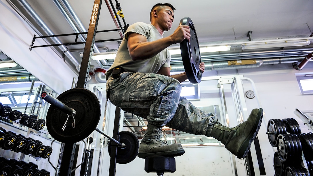 Air Force Airman 1st Class Nikko Madarang balances on one leg and squats while working out at Ramstein Air Base, Germany, June 1, 2017. Madarang is a passenger service specialist assigned to the 721st Aerial Port Squadron. Air Force photo by Airman 1st Class Savannah L. Waters