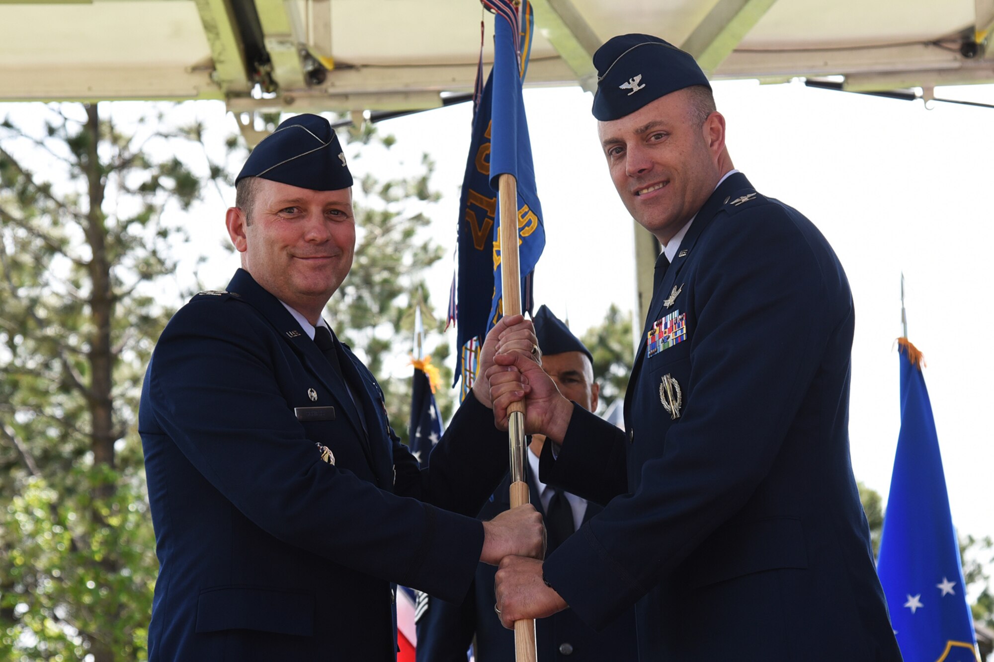 CHEYENNE MOUNTAIN AIR FORCE STATION, Colo. - Col. Doug Schiess, 21st Space Wing commander, passes the guidon to Col. Robert Moose as he assumes command of the 721st Mission Support Group at Cheyenne Mountain Air Force Station, Colo., June 1, 2017. 721st MSG provides civil engineering, communications, contracting logistics, personnel, security, and services support to Airmen, civilians and contractors stationed at Cheyenne Mountain AFS. (U.S. Air Force photo by Robb Lingley)