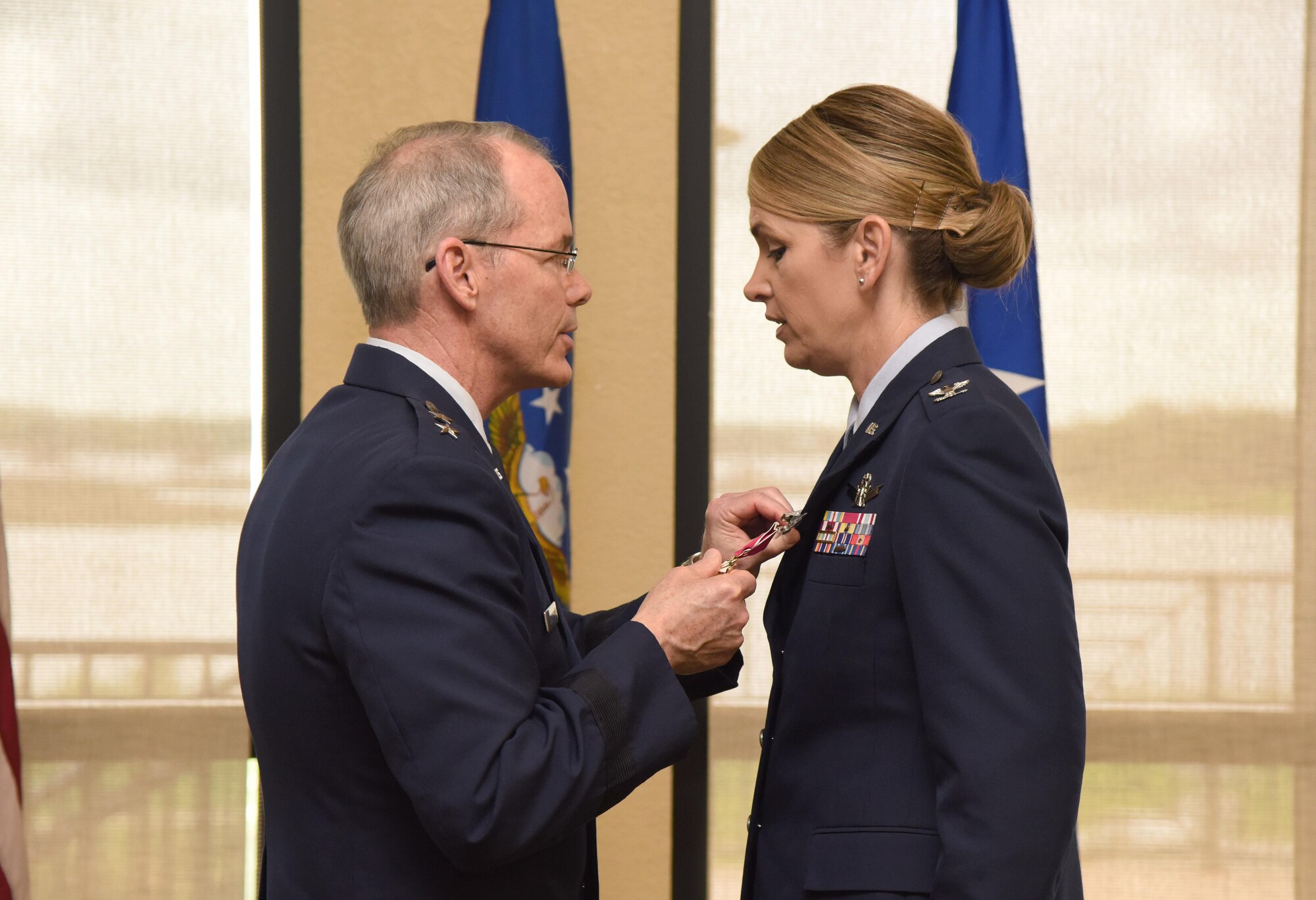 Maj. Gen. Bob LaBrutta, 2nd Air Force commander, presents the Legion of Merit medal to Col. Michele Edmondson, outgoing 81st Training Wing commander, during a change of command ceremony at the Bay Breeze Event Center June 2, 2017, on Keesler Air Force Base, Miss. The ceremony is a symbol of command being exchanged from one commander to the next by the handing-off of a ceremonial guidon. Edmondson is now assigned to be the executive officer to the vice chief of staff of the Air Force at the Pentagon in Washington D.C. (U.S. Air Force photo by Kemberly Groue) 